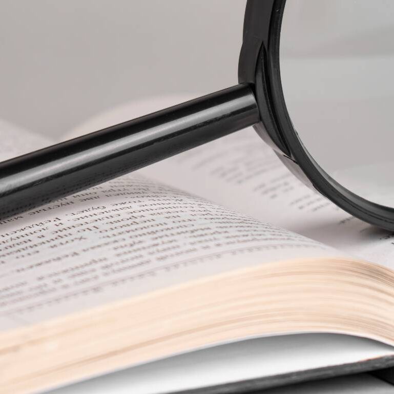 magnifying-glass-opened-old-book-searching-reading-concept2